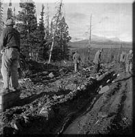 Men, mud and ruts on the old Alaska Highway.