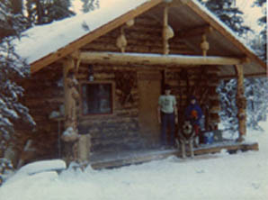 Katherine, Ricky and Von Hairy the dog in front of the nearly finished cabin.